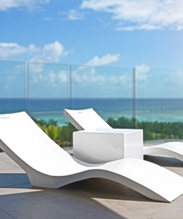 Sleek white fiberglass loungers on luxury decking.